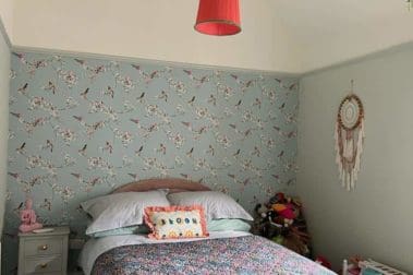 guest bedroom with freshly painted interior, wallpaper fitted and decorated with bed