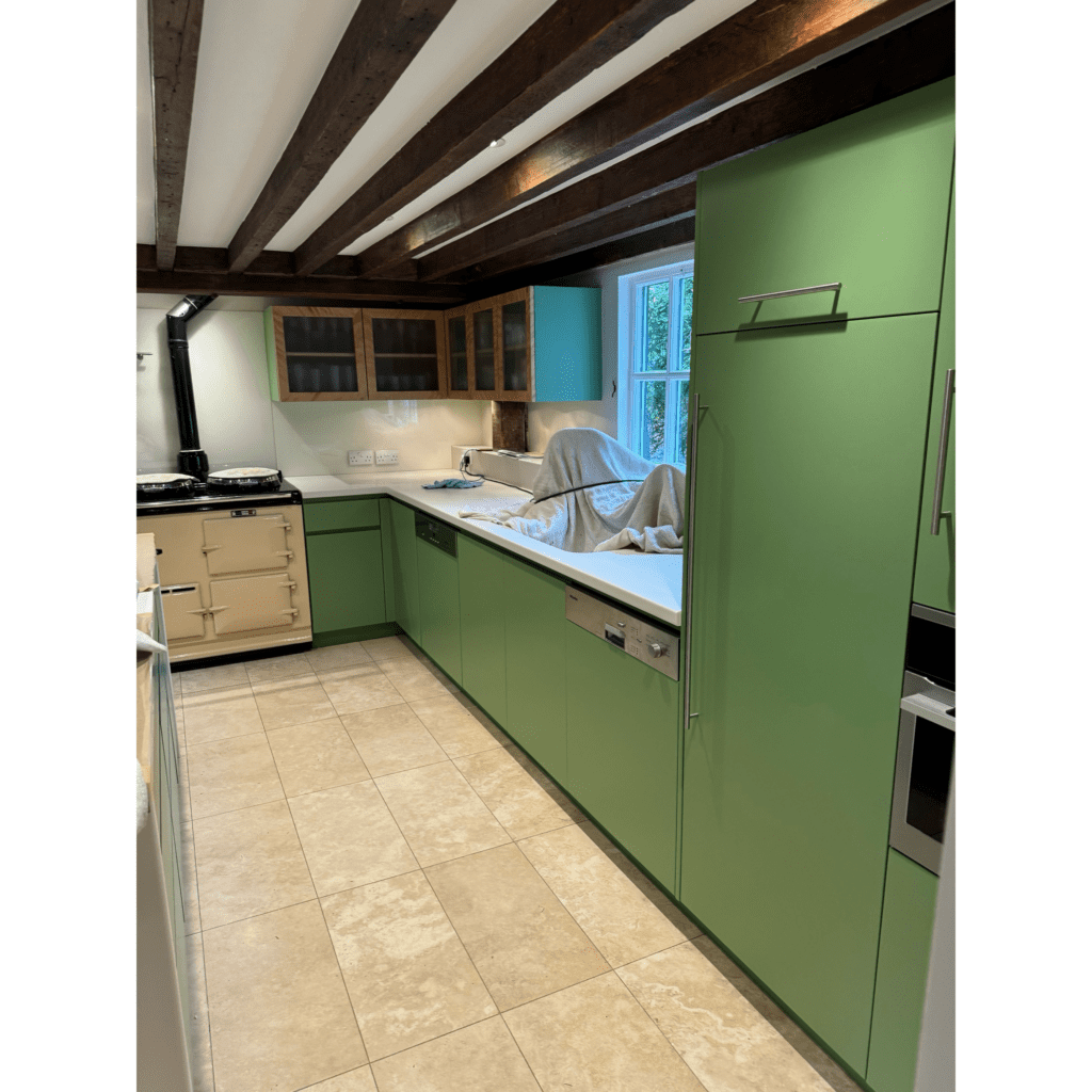 open-plan kitchen with green painted cabinets