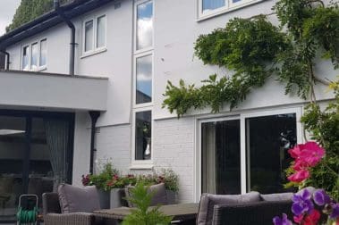 Freshly painted house exterior walls in grey and white